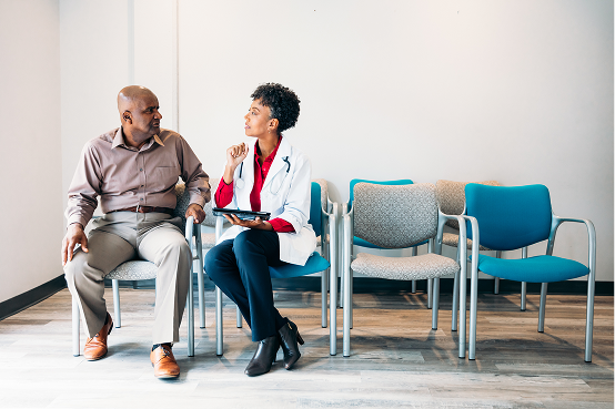 Clinician discussing clinical trial results with two patients