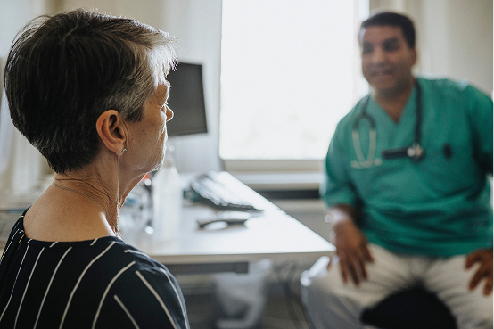 Healthcare provider talking with a patient about cancer treatment options